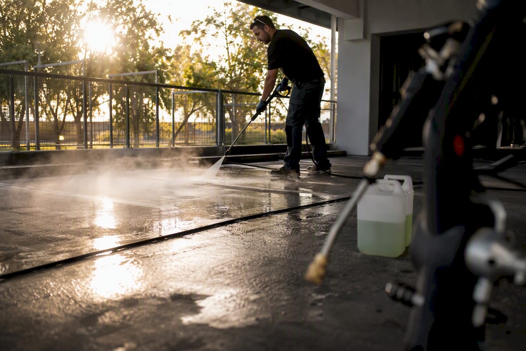 Hot water pressure washing concrete car park surface