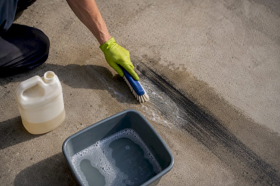 Brush applying cleaner to rubber mark