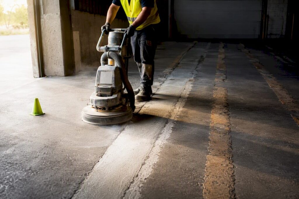 Contractor grinding old warehouse line markings