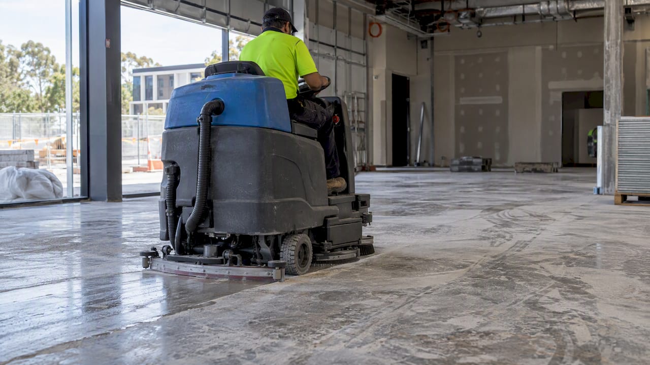 Floor scrubber collecting settled construction dust