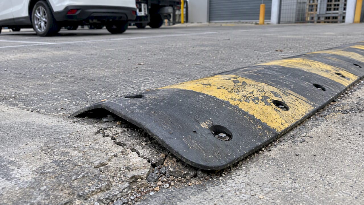 Cleaned speed hump revealing surface defects